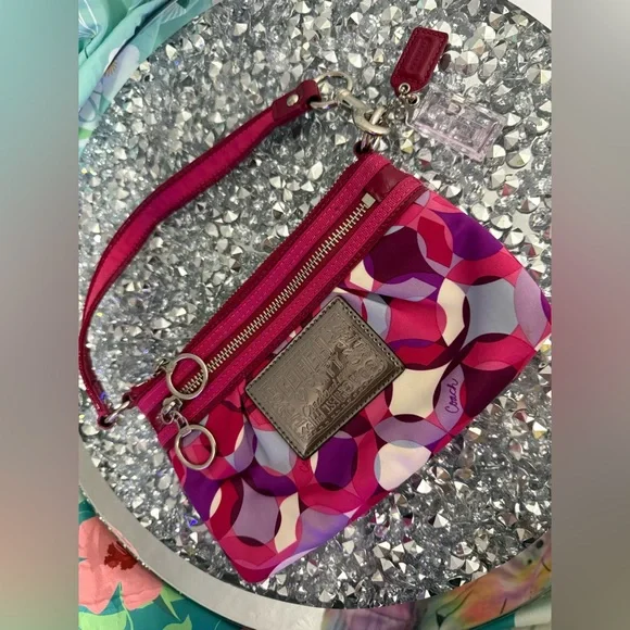 Coach Poppy Wristlet featuring a pink and purple geometric pattern. - Picture 9 of 9